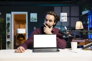 Entertainer presents mockup laptop, debating whether to recommend it to viewers or not. Content creator doing thinking hand gesturing, unsure of how to review isolated screen notebook photo