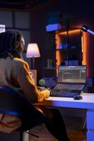 Technician in home office typing code on notebook device, developing software programs, entering commands. Skillful gen Z teenager at home fixing errors in application, implementing new features photo