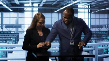 System administrators looking at holograms in data center, doing swiping motions hand gestures. Server farm workplace employees interacting with augmented reality tech, camera A photo
