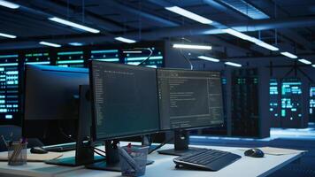 Multi monitor computer setup in data center used for monitoring security threats threatening rigs. Trucking right shot of PCs used by futuristic server hub admins ensuring compliance with regulations photo