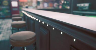 Detailed view of a bar counter with decorative lighting in a lively setting video
