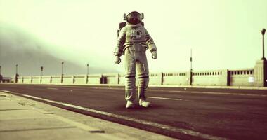 Astronaut walks along empty road in a surreal landscape during daylight video