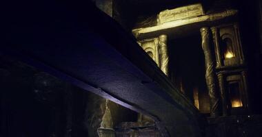 Ancient architecture illuminated by flickering lights in hidden cave video