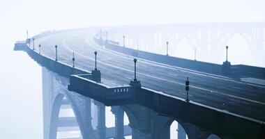 Fog envelops a curving bridge creating an ethereal atmosphere video