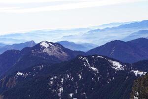 A person standing on top of a mountain photo