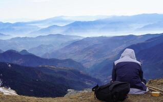 A person sitting on a rock photo