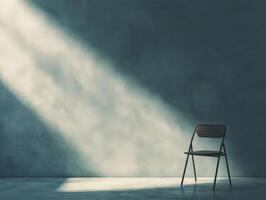 A solitary chair in a dimly lit space, creating a contemplative atmosphere. photo