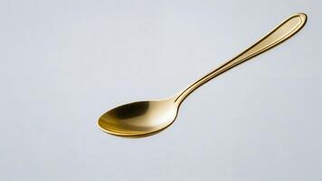 Gold spoon isolated on white background. photo