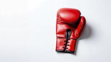 Single red leather boxing glove on white background. photo