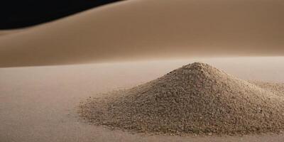Small pile of sand against a desert dune backdrop. photo
