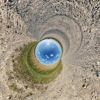 A view of a blue sky from inside a hole photo