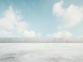 A serene outdoor space with a concrete surface and a clear blue sky filled with clouds. photo