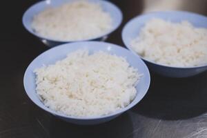 Bowl of tasty cooked white rice on table photo
