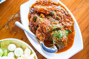 Fried fish with red curry paste photo