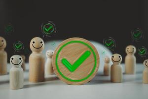 Green colored check mark in circle frame wood block with many people check mark in speech bubble photo