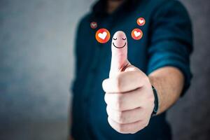 Businessman thumbs up showing happy smile face and red heart emotion, good satisfaction feedback rating. photo