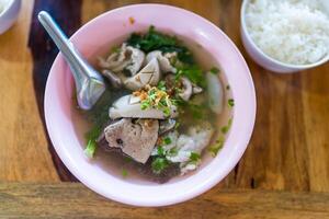 Thai style boiled clear soup with pork entrails pork blood cubes and liver in bowl. Healthy and rich in iron and protein photo