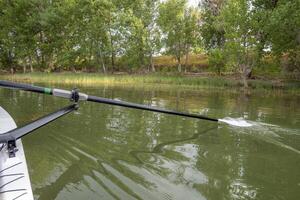 sculling oar on a calm lake, Boyd Lake in Colorado photo