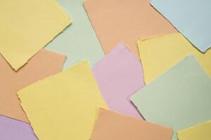 background of random square art paper reminder notes in pastel colors photo