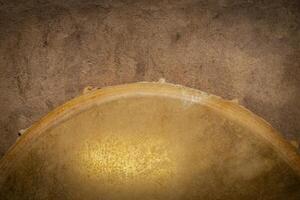 detail of handmade, native American style, shaman frame drum against textured paper photo