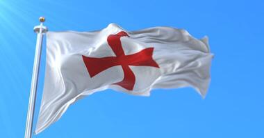 Knights templar flag waving in blue sky. Loop video