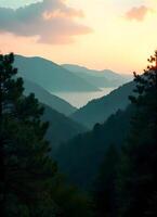 A view of the mountains at sunset with trees in the foreground photo