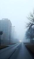 A foggy street with a tree in the middle photo