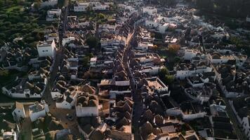 Flight over the center of Alberobello. The city is famous for the amazing architecture of the Truli houses. Alberobello is visited by millions of tourists a year. Sunset over Truli. video