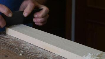 Luthier working with a wood block in the workplace video
