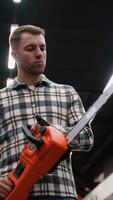 Lumberjack Selecting a Chainsaw in a Hardware Store video