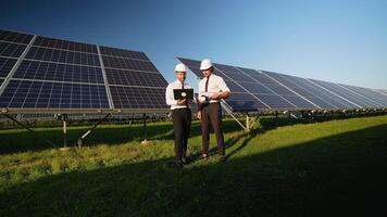 Two Engineers Discuss Solar Panel Performance on Site video