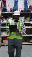 Warehouse Worker Walking Through Aisle with Clipboard video