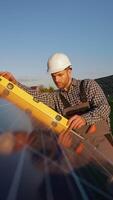 Worker Uses Level Tool to Verify Solar Panel Installation video