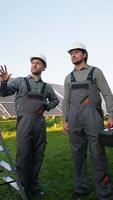 Workers Discussing Solar Panel Installation with Tools video