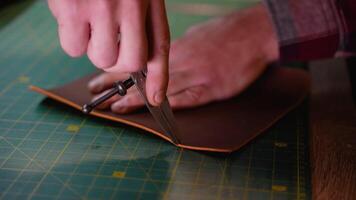 Craftsman Using a Compass to Mark Leather for Precise Cutting video