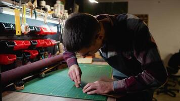 Craftsman Cutting Leather with Precision in a Workshop video