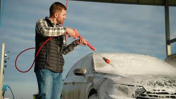 Man Applying Foam on Car Windshield at Outdoor Car Wash video