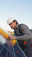 Worker Verifies Solar Panel Installation with Precision Tool video
