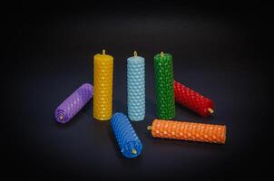 Candles of different colors on a black background, chakra candles. High quality photo