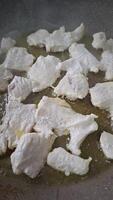 pieces of chicken breast meat frying on a frying pan with slow motion video