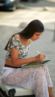 A young woman engaged in using a tablet while in an urban setting, showcasing modern life video