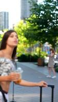 A Young Woman is Savoring a Refreshing Drink in a Vibrant and Lively Urban Atmosphere video
