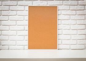 Cork board mounted on a white brick wall, ideal for organizing notes and displaying photos
