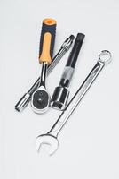 Essential hand tools including a ratchet, extension, and wrench for various mechanical tasks at a workshop photo