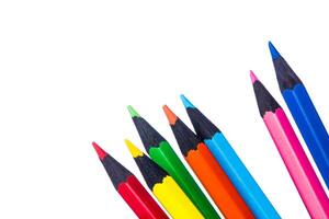 Colorful collection of pencils arranged in a row on white background ready for creative projects and art activities photo
