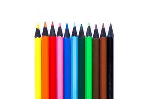 Bright colored pencils arranged neatly in a row for artistic activities and creative projects photo