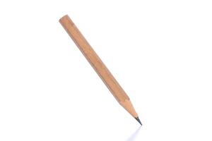 Simple wooden pencil standing on its tip against a clean white background showcasing its sharp lead photo