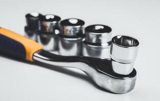 Wrench set with socket attachments arranged neatly on a white surface for clear visibility and easy access photo