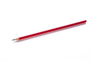 Red pencil resting on a white surface with a sharp tip and a smooth body ready for writing or drawing work photo