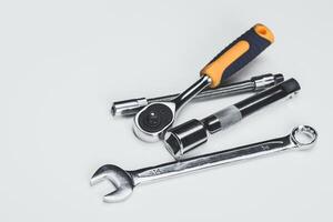 Different types of hand tools arranged for mechanical tasks on a light background photo